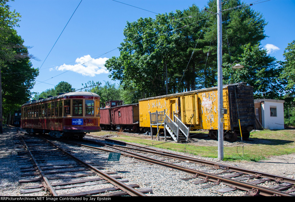 A former Toronto Streetcar stands next to a badly faded MILW Boxcar